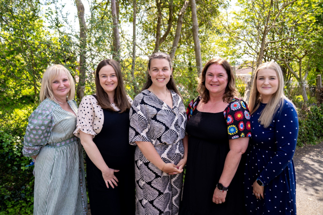 A staff photo with 5 members